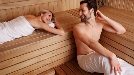 Couple relaxing together in a sauna cabin - Cedar Inn, Darjeeling