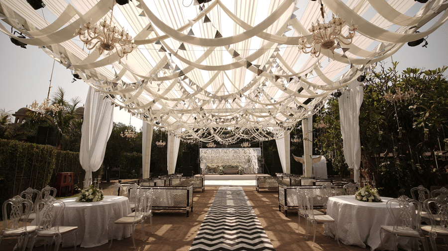 a decorated walkway to the stage with seating arrangements on the side - heritage village resorts & spa, Manesar