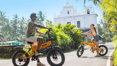 Guests riding electric bikes near the heritage site in Goa.