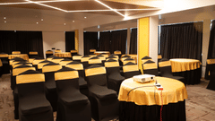 Banquet hall at Magnus Lxia Premier, Kalyani Nagar with round table setup and modern ceiling lighting.