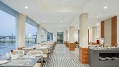 interiors of the Sattva restaurant with comfortable seating at Pride Elite Becharaji