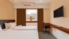 view of a king size bed of a room at Pride Elite Becharaji