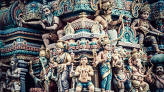 A close up image of many deities carved on the temple roof