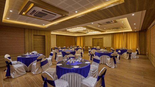 Side view of the round table seating in the banquet hall at Grand Continent - A Sarovar Premiere Affiliate Hotel, Hosur