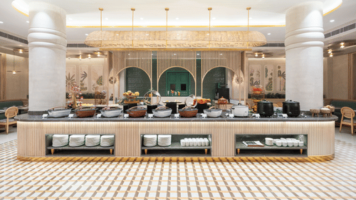 A bar counter with a patterned tile floor in a luxurious hotel.