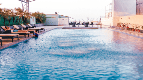 image of swimming pool with lounge area at the deck at Pride Plaza Hotel Kolkata