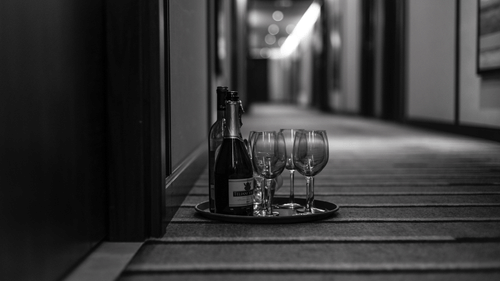 Champagne and glasses kept outside a hotel room
