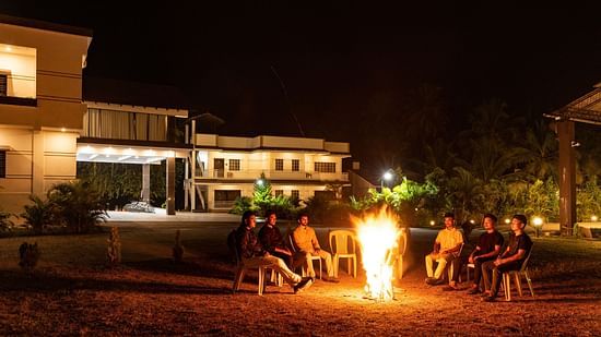 A group of people sitting around a campfire talking - Mastiff Select Terrain