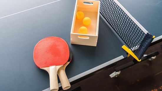 table tennis rackets and balls kept on the table