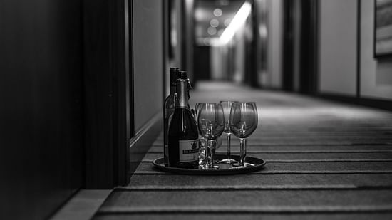Champagne and glasses kept outside a hotel room