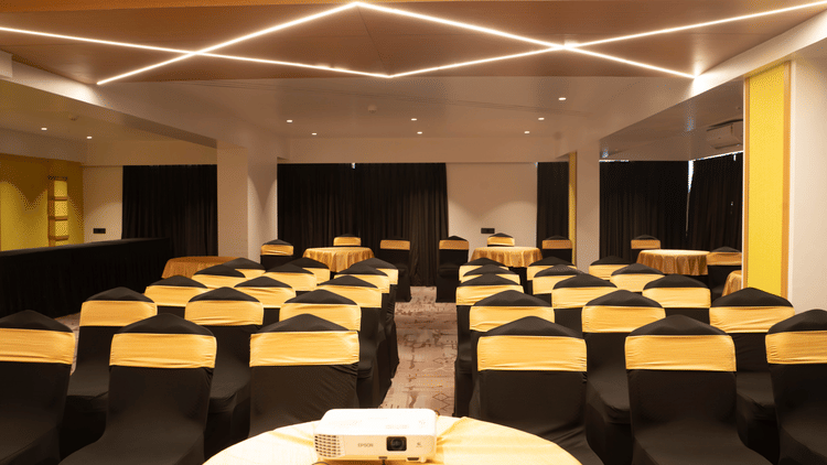 Banquet hall at Magnus Lxia Premier, Kalyani Nagar with modern lighting and round table arrangements.