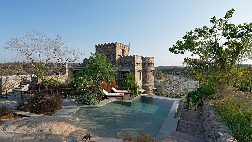 Overview of the swimming pool with stairs leading to a stone structure - Chunda Shikar Oudi, Udaipur