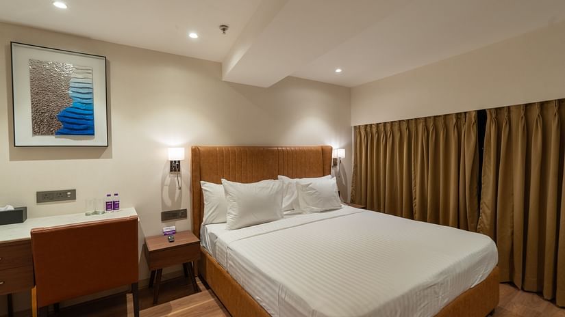 an image of a bedroom with a portrait beside it at Clarks Inn Suites Hyderabad 