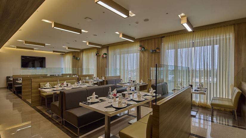 Seating arrangements in the restaurant at Grand Continent - A Sarovar Premiere Affiliate Hotel, Hosur