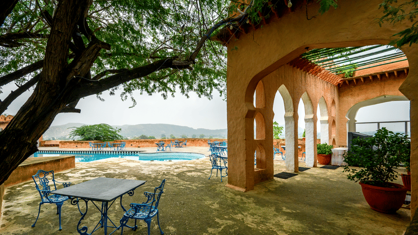 Hill Fort Kesroli 14th Century Alwar - view of a table and chairs placed under a tree