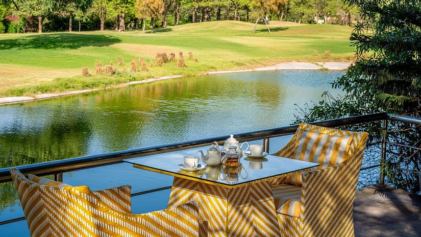 a table set for two with a view of the lake
