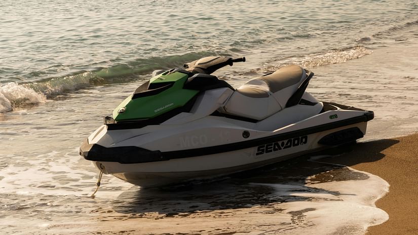 Jet ski on the beach shore as the gentle waves are crashing against the shore