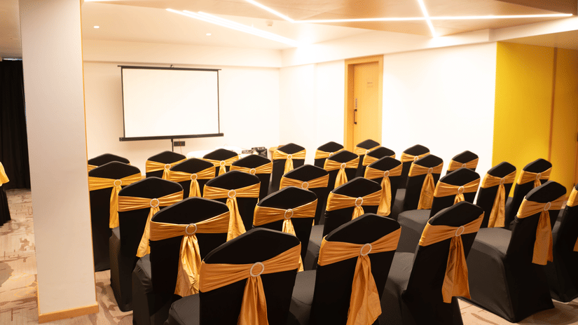 Conference room at Magnus Lxia Premier, Kalyani Nagar with theatre-style seating and presentation screen.