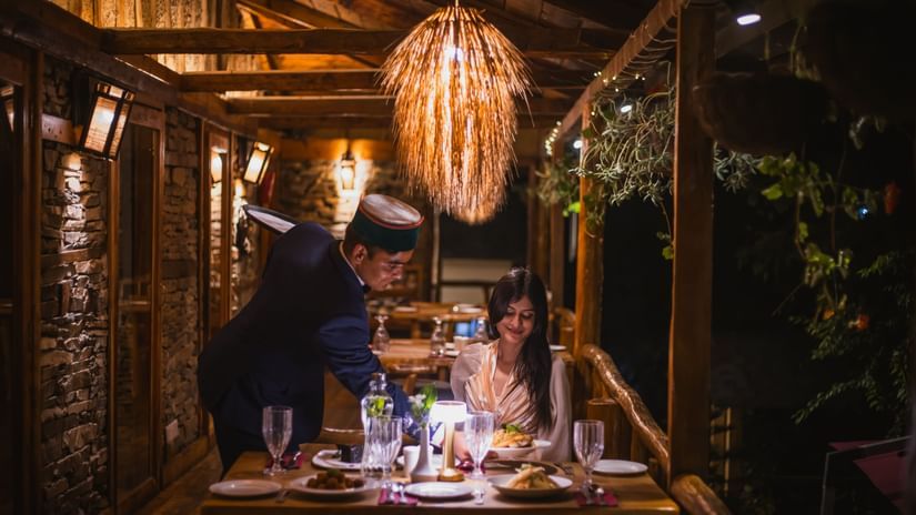 A candlelit dinner being served at the outdoor restaurant of The Manor Luxury Apartments, Shimla.