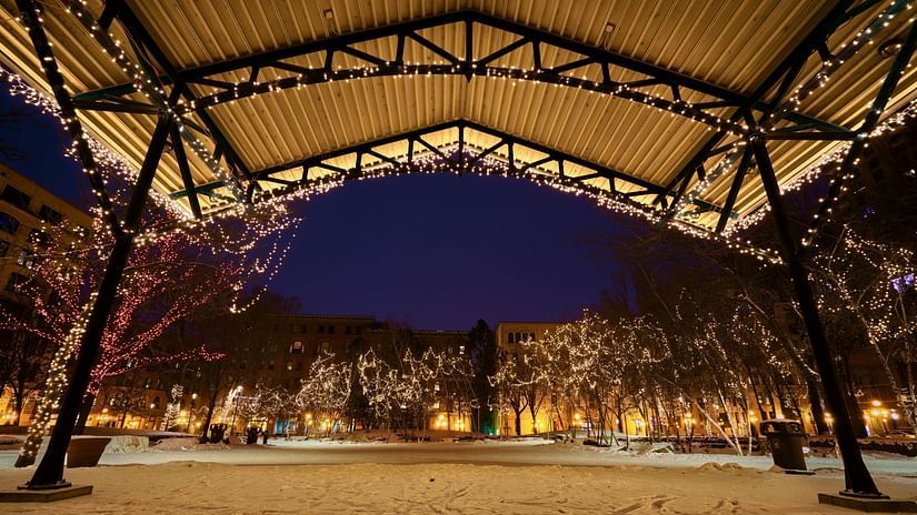 Image of a park decorated lights during evening.