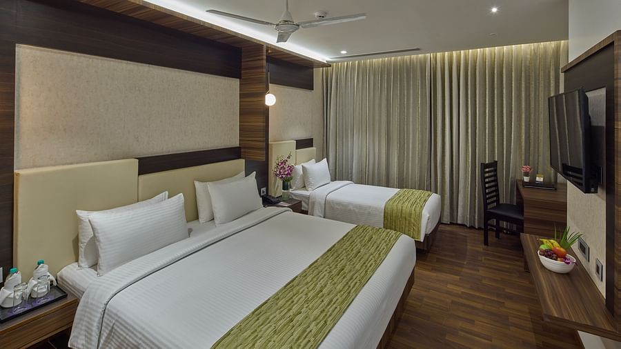 A king bed, a single bed inside the suite at Grand Continent - A Sarovar Premiere Affiliate Hotel, Hosur