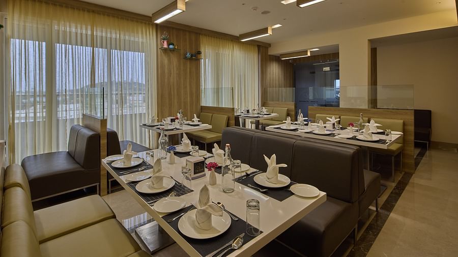 Another view of the seating arrangements in the restaurant at Grand Continent - A Sarovar Premiere Affiliate Hotel, Hosur