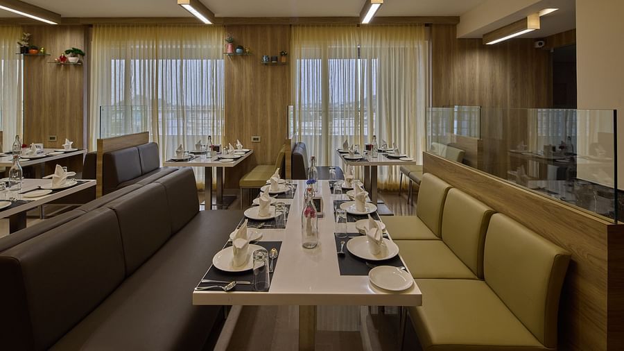 Close up of the seating arrangement in the restaurant at Grand Continent - A Sarovar Premiere Affiliate Hotel, Hosur