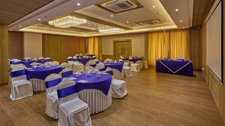 Round table seating in the banquet hall at Grand Continent - A Sarovar Premiere Affiliate Hotel, Hosur