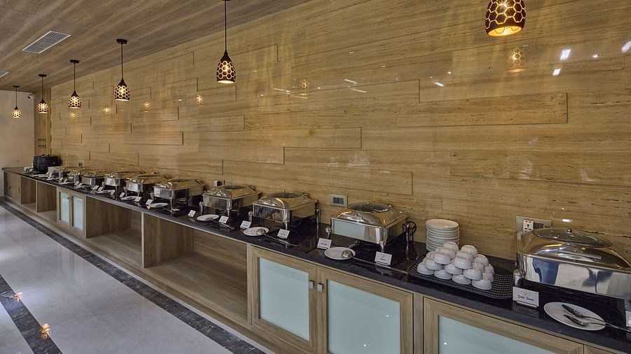 Side view of the buffet station at the restaurant at Grand Continent - A Sarovar Premiere Affiliate Hotel, Hosur