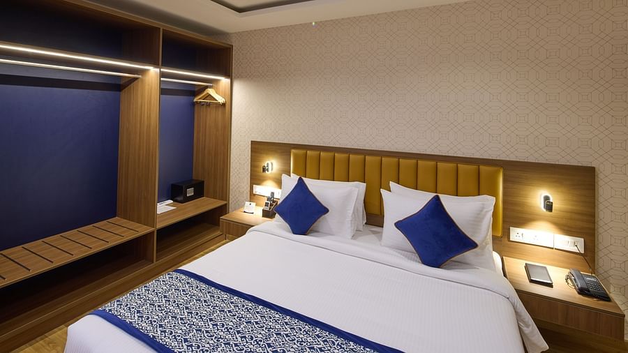 A spacious hotel room in Bengaluru with a king size bed and accent lighting - Grand Continent, Brookefield