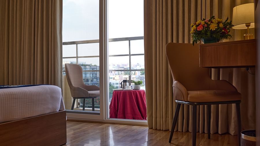 An inviting balcony seen from our hotel room, featuring a chair for relaxation - Grand Continent, Brookefield