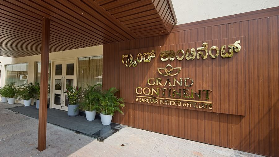 A wooden signboard displaying our hotel name in both Kannada and English - Grand Continent, Brookefield
