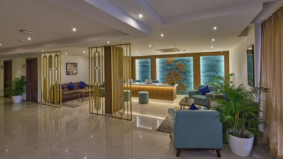 A spacious lounge area with cosy seating arrangement and potted plants - Grand Continent, Brookefield