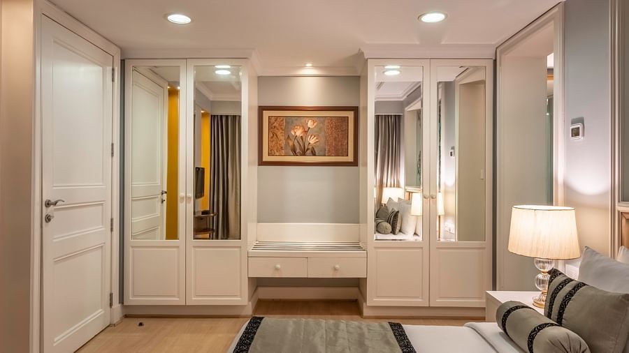 side view of the bed in the Junior Suite with wardrobes in the backdrop - Kenilworth Hotel, Kolkata