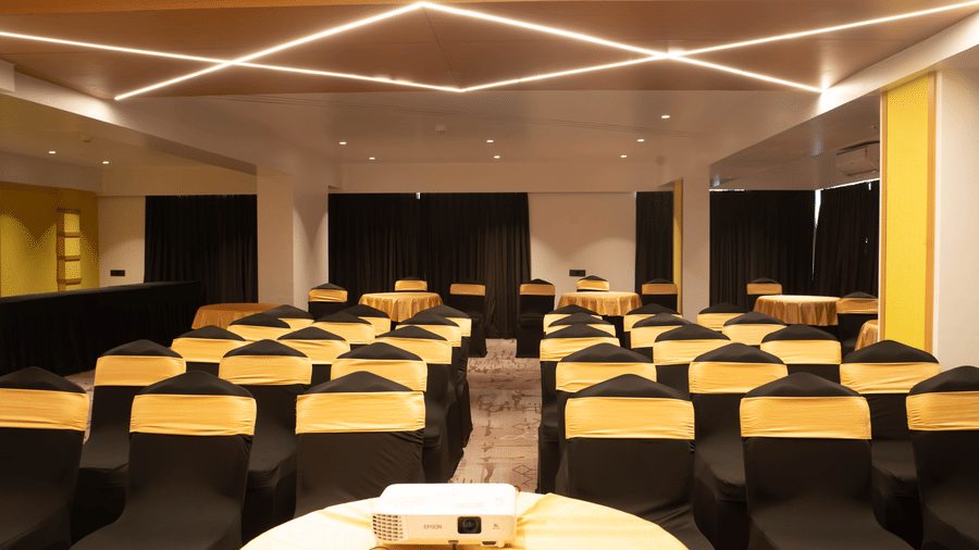 Banquet hall at Magnus Lxia Premier, Kalyani Nagar with modern lighting and round table arrangements.