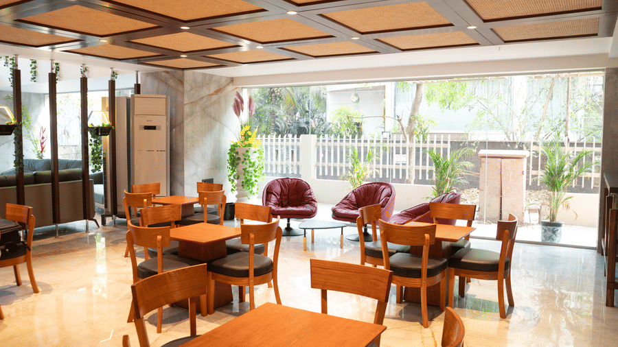 Cosy cafe seating area at Magnus Lxia Premier, Kalyani Nagar with natural light and contemporary décor.
