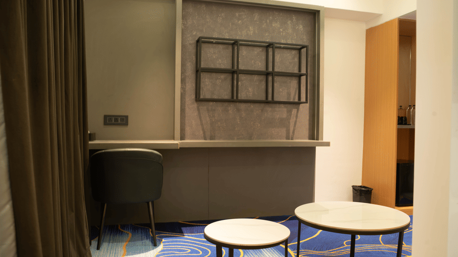 Hotel room interior at Magnus Lxia Premier, Kalyani Nagar with seating area and stylish décor.