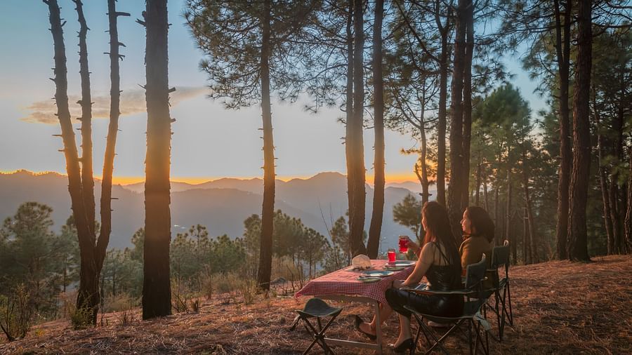 The Manor Shimla - Two women looking at the mountains with cutlery placed on the table in front of them