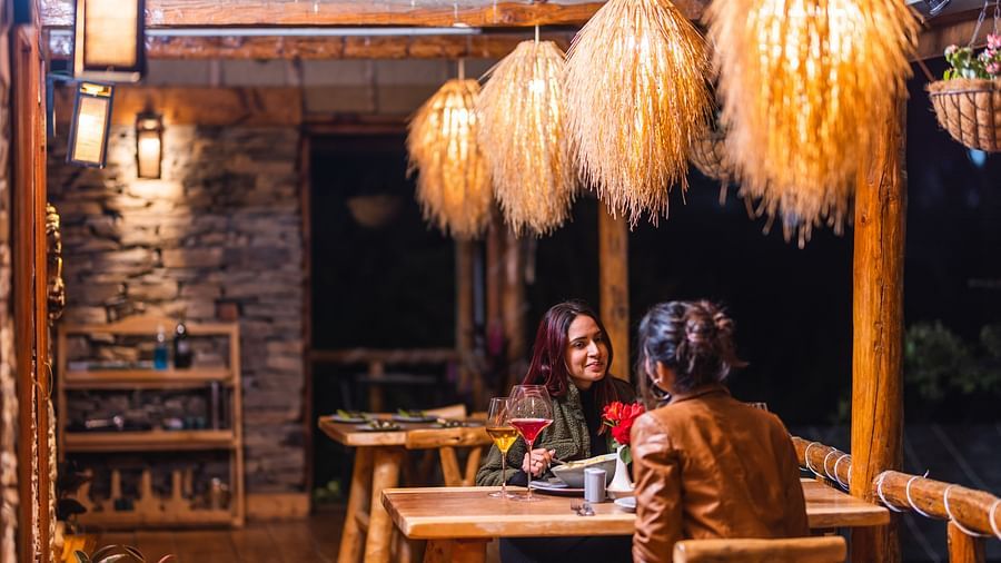  Two women sitting across each other in our outdoor seating arrangement - The Manor Luxury Hotel, Shimla