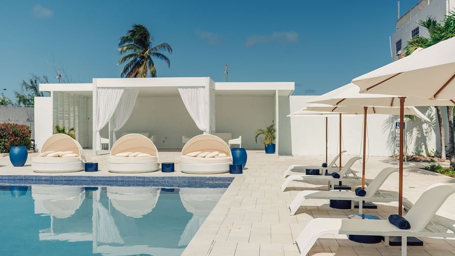 Soco House - the view of the swimming pool with pool beds placed on the side of the pool