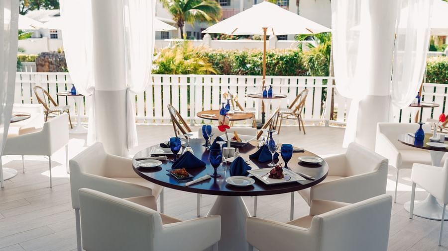 The Soco House - the outside seating area of the restaurant with a round table and chairs