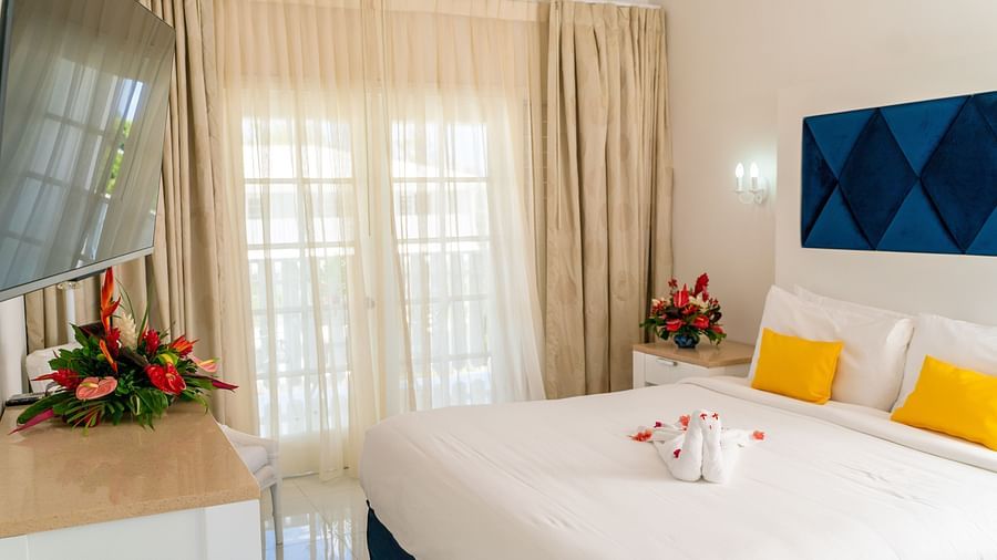 Soco House - view of a bed with yellow pillows kept on it 1