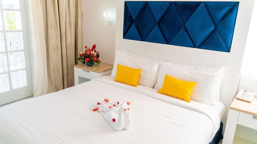 Soco House - view of a bed with yellow pillows kept on it