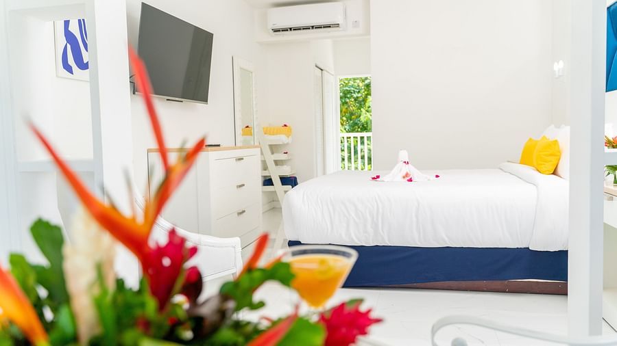 The Soco House - view of a bed facing a TV