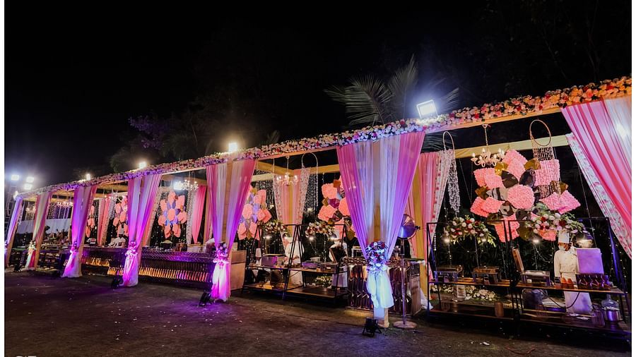 the outdoor venue prepped with decorated furniture adorned with pink curtains - Wedlock Greens Hotel Resorts Dhanbad