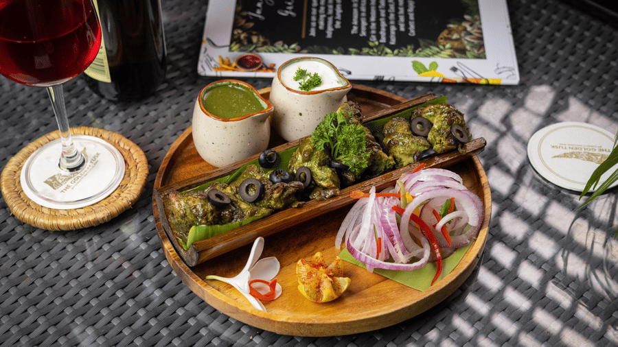 Meal with several small dishes containing various foods and drinks at The Golden Tusk, Jim Corbett