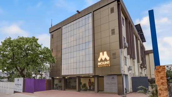 Mount Amara Hotel & Spa in Siliguri showcasing a contemporary building with reflective glass facade, clean lines, and landscaped entrance area.