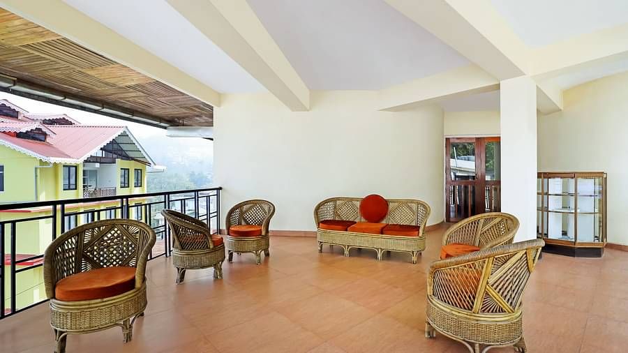 A full view of the sit-out area that has chairs and a sofa | Summit Newa Regency & Spa, Pelling