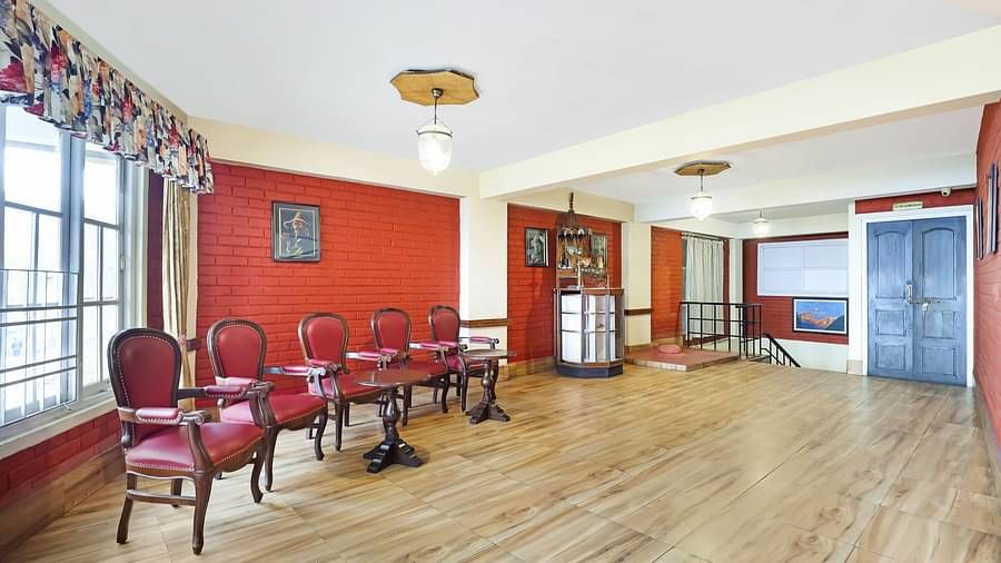 A side view of chairs placed in a row in a huge hall | Summit Newa Regency & Spa, Pelling