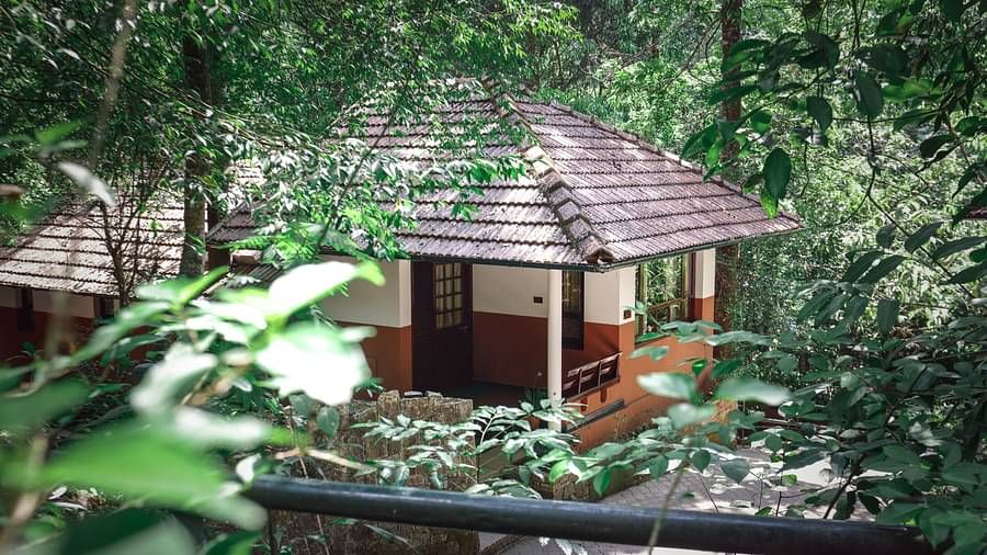 An exterior view of a villa nestled in greenery | Vythiri Resort. Wayanad